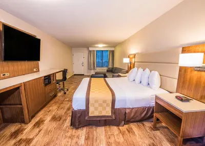 a hotel room with a large bed and a desk at Travelodge by Wyndham Culver City in Los Angeles