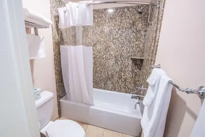 a bathroom with a shower and a toilet at Travelodge by Wyndham Culver City in Los Angeles