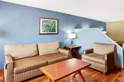 a living room with a couch and a table at Travelodge by Wyndham Culver City in Los Angeles