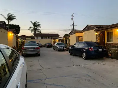 a group of cars parked in a parking lot at Apache Inn in Lynwood