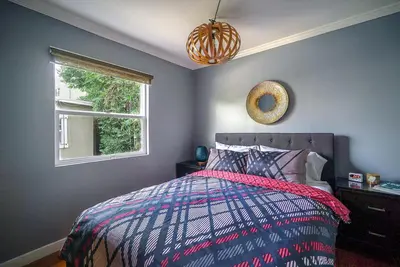 a bedroom with a bed and a window at Stylish 2 Bed & 2 Bath at the Heart of Hollywood with Free Parking - One Car only in Los Angeles
