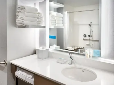 a white bathroom with a sink and a mirror at Hampton Inn & Suites Anaheim Resort Convention Center in Anaheim