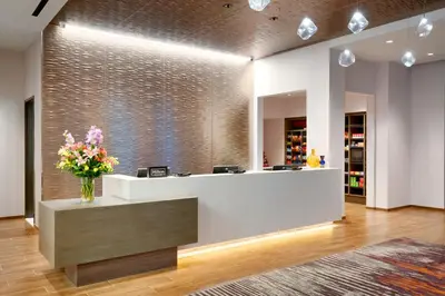 a lobby with a reception desk with flowers in a vase at Hampton Inn & Suites Anaheim Resort Convention Center in Anaheim