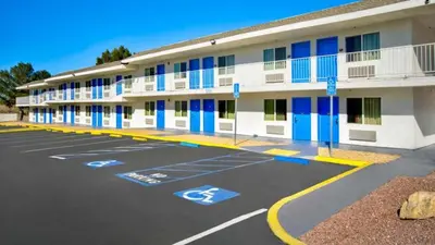 an empty parking lot in front of a hotel at Motel 6 Victorville in Victorville
