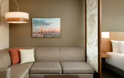 a living room with a couch and a bed at Hyatt Place Pasadena in Pasadena