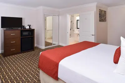 a hotel room with a bed and a television at Best Western Plus LA Mid-Town Hotel in Los Angeles