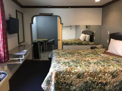 a hotel room with a bed and a desk at Starlight Inn, Valley Blvd - Downtown LA in Los Angeles