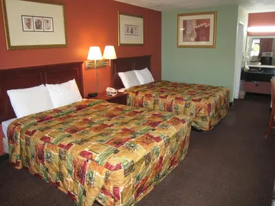 a hotel room with two beds and a sink at Motel 8 Maricopa in Maricopa