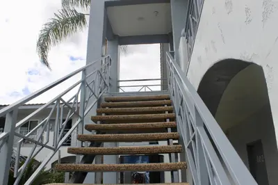 a staircase leading up to a building with a palm tree at Crescent Inn in Wilmington