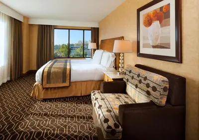 a hotel room with a bed and a couch at DoubleTree Suites By Hilton Anaheim Resort/Convention Center in Anaheim