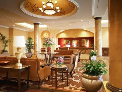 a lobby of a hotel with tables and chairs at DoubleTree Suites By Hilton Anaheim Resort/Convention Center in Anaheim