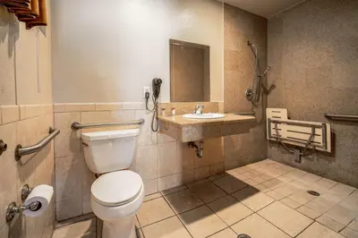a bathroom with a toilet and a sink at Oak Park Motel in Monrovia