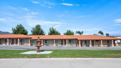 a building with a statue in front of it at Oak Park Motel in Monrovia