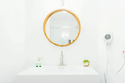 a bathroom with a mirror on a sink at The Belmont Shore Inn in Long Beach