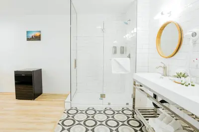 a bathroom with a shower and a sink at The Belmont Shore Inn in Long Beach
