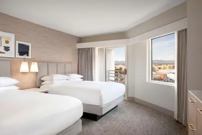 a hotel room with two beds and a window at Hilton Santa Monica in Los Angeles