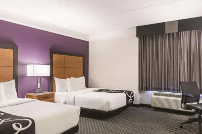 a hotel room with two beds and purple walls at La Quinta Inn & Suites by Wyndham Ontario Airport in Ontario