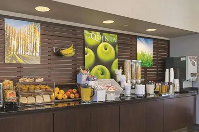 a buffet line in a hotel with fruits and vegetables at La Quinta Inn & Suites by Wyndham Ontario Airport in Ontario