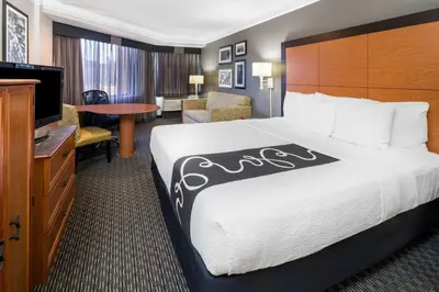 a hotel room with a bed and a flat screen tv at La Quinta by Wyndham Buena Park in La Palma