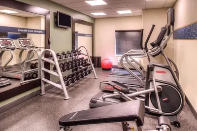 a gym with cardio equipment and tread machines at Hampton Inn & Suites Ontario in Ontario