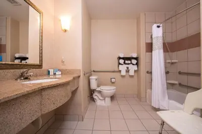 a hotel bathroom with a toilet and a sink at Hampton Inn & Suites Ontario in Ontario