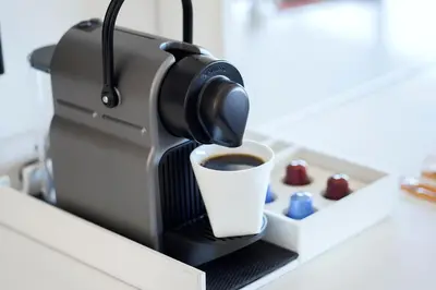 a coffee maker with a cup of coffee on a counter at Huntley Santa Monica Beach in Los Angeles
