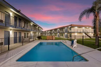 a swimming pool in front of a building at Days-Inn by Wyndham Bakersfield in Bakersfield
