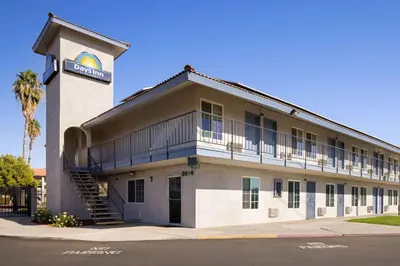 a building with a sign on the side of it at Days-Inn by Wyndham Bakersfield in Bakersfield