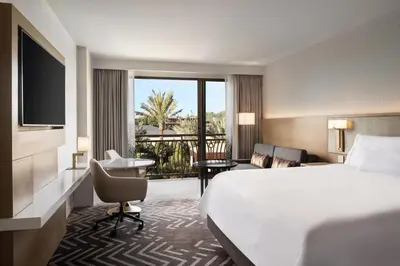 a hotel room with a bed and a balcony at The Westin Anaheim Resort in Anaheim