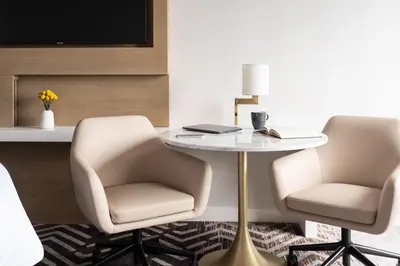 two chairs and a table in a room with a desk at The Westin Anaheim Resort in Anaheim