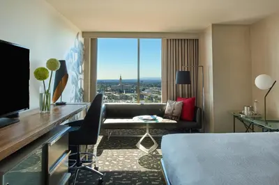 a hotel room with a bed and a large window at Kimpton Hotel Palomar Los Angeles Beverly Hills by IHG in Los Angeles