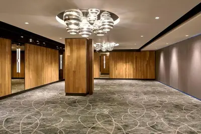 a large room with a chandelier and wooden walls at Kimpton Hotel Palomar Los Angeles Beverly Hills by IHG in Los Angeles