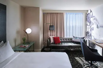 a hotel room with a bed and a couch at Kimpton Hotel Palomar Los Angeles Beverly Hills by IHG in Los Angeles