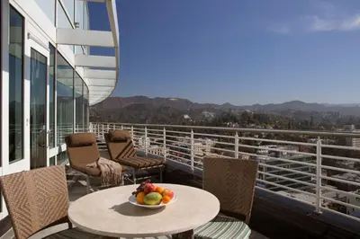 a bowl of fruit on a table on a balcony at Loews Hollywood Hotel in Los Angeles