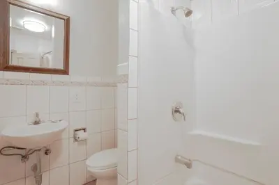 a bathroom with a sink and a toilet and a mirror at Economy Inn Hollywood in Los Angeles