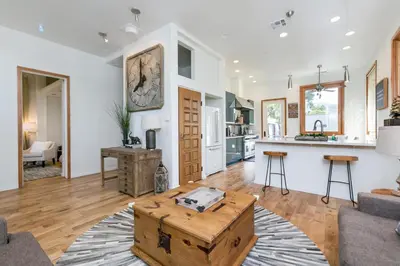 a living room with a table and a kitchen at Stunning 2-Bedroom Home near Downtown Culver in Los Angeles