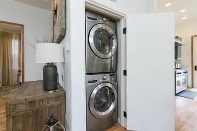 a laundry room with two washer and dryer at Stunning 2-Bedroom Home near Downtown Culver in Los Angeles