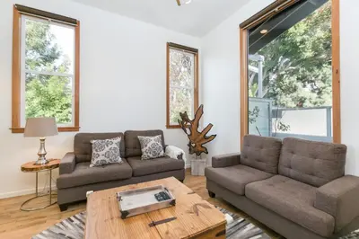 a living room with two couches and a table at Stunning 2-Bedroom Home near Downtown Culver in Los Angeles