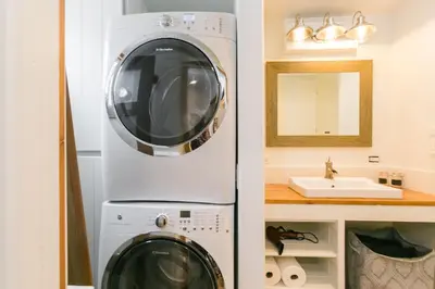 a washer and dryer in a bathroom with a sink at Charming 1-Bedroom Home near Downtown Culver in Los Angeles