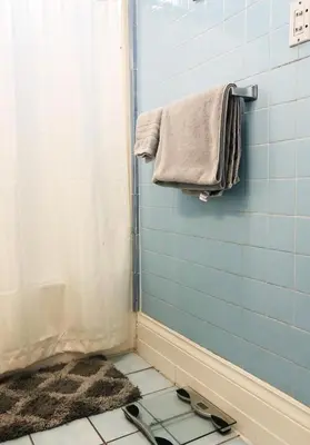 a bathroom with a shower with a towel and a rug at Cozy Suite near City of hope in Duarte