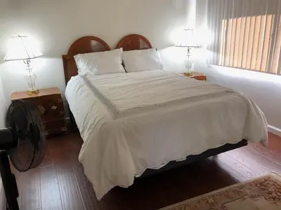 a bedroom with a large bed with two lamps at Hollywood Hills private room in Los Angeles