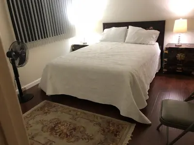 a bedroom with a large bed with white sheets and pillows at Hollywood Hills private room in Los Angeles