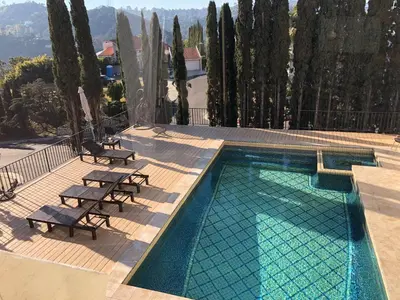 a swimming pool with two lounge chairs next to at Hollywood Hills private room in Los Angeles