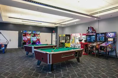 a room with two pool tables and arcade games at WorldMark Anaheim in Anaheim