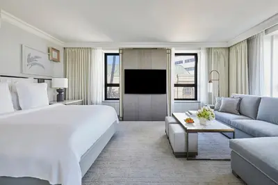 a hotel room with a large bed and a couch at Beverly Wilshire, Beverly Hills, A Four Seasons Hotel in Los Angeles