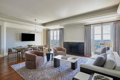 a living room with a couch and a dining room at Beverly Wilshire, Beverly Hills, A Four Seasons Hotel in Los Angeles