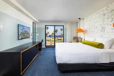 a hotel room with a large bed and a large window at Hotel Erwin Venice Beach in Los Angeles
