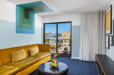 a living room with a couch and a table at Hotel Erwin Venice Beach in Los Angeles