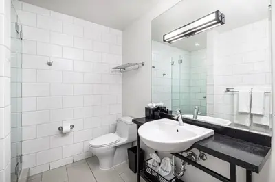 a white bathroom with a sink and a toilet at Hotel Erwin Venice Beach in Los Angeles