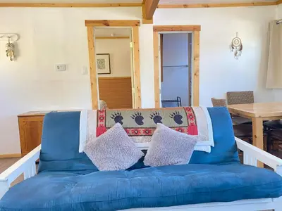 a blue couch in a living room with a table at Blue Horizon Lodge in Big Bear Lake